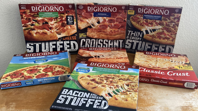 seven DiGiorno pizza boxes stacked